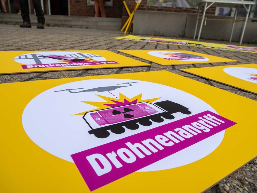Foto: Protest-Transparent mit einem Atomtransporte und der Aufschrift "Drohnenangriff"